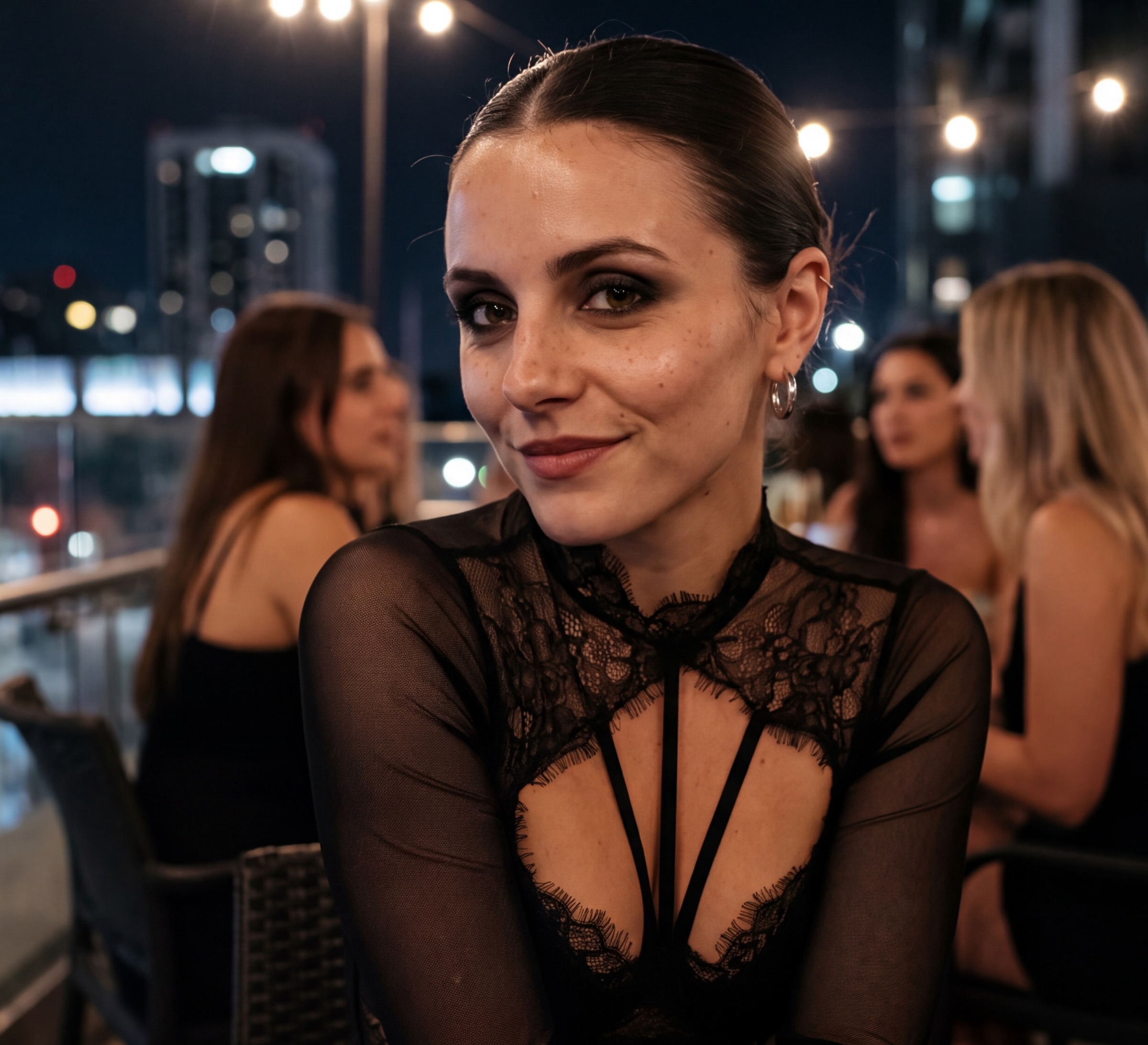 Close portrait of Soaira on a terrace at night, sheer black top, city lights